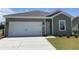 Charming single-story home with a neutral color palette, concrete driveway, and attached two-car garage at 958 Oak Hollow St., Longs, SC 29568