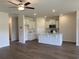 Open floor plan with kitchen featuring white cabinets, stainless appliances, and laminate floors at 958 Oak Hollow St., Longs, SC 29568