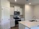 Bright kitchen featuring stainless steel appliances, white cabinets, and laminate floors at 958 Oak Hollow St., Longs, SC 29568