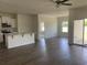 Open-concept living room featuring modern flooring, neutral tones, kitchen island, and ample natural light at 958 Oak Hollow St., Longs, SC 29568