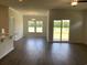 Bright open floor plan with laminate floors, a ceiling fan, and sliding glass doors to the back patio at 958 Oak Hollow St., Longs, SC 29568