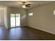 Living room featuring laminate floors, sliding glass doors to the back yard, and a ceiling fan at 958 Oak Hollow St., Longs, SC 29568