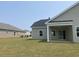 Spacious backyard with covered patio, perfect for entertaining, and a well-maintained lawn at 962 Oak Hollow St., Longs, SC 29568