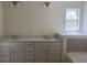 Bright bathroom features a double vanity with stone countertops and a window providing natural light at 962 Oak Hollow St., Longs, SC 29568