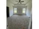 Spacious bedroom with neutral carpet, tray ceiling, and two windows letting in plenty of natural light at 962 Oak Hollow St., Longs, SC 29568