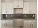 Modern kitchen featuring white cabinets and stylish backsplash at 962 Oak Hollow St., Longs, SC 29568