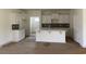 Well-lit kitchen with white cabinets and a central island at 962 Oak Hollow St., Longs, SC 29568