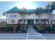 Charming exterior of The Oceanfront Litchfield Inn with lush landscaping at 1 Norris Dr. # 210, Pawleys Island, SC 29585