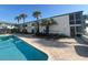 Beautiful pool area with lounge chairs and palm trees nearby at 1 Norris Dr. # 210, Pawleys Island, SC 29585
