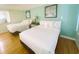 Room with two beds, wood flooring, neutral walls, and stylish decorations at 1 Norris Dr. # 210, Pawleys Island, SC 29585