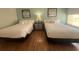 Bright room with two beds, wood flooring and beach-themed decor at 1 Norris Dr. # 210, Pawleys Island, SC 29585