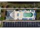 Aerial view of a community pool, lounge seating, and parking area surrounded by lush landscaping at 100 Birch N Coppice Dr. # 12, Surfside Beach, SC 29575