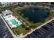 Aerial view of the community pool, pond with fountain, and parking area at 100 Birch N Coppice Dr. # 12, Surfside Beach, SC 29575