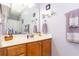 This bathroom features a vanity with storage, a mirror and lavender towels at 100 Birch N Coppice Dr. # 12, Surfside Beach, SC 29575