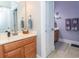 Well-lit bathroom with a vanity, mirror, and adjacent water closet provides convenience and privacy at 100 Birch N Coppice Dr. # 12, Surfside Beach, SC 29575