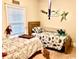 Charming bedroom featuring twin beds, playful decor, and ample natural light from the window at 100 Birch N Coppice Dr. # 12, Surfside Beach, SC 29575