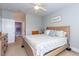 Cozy bedroom with a bed, ceiling fan, and ensuite bathroom is perfect for relaxation at 100 Birch N Coppice Dr. # 12, Surfside Beach, SC 29575