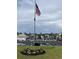 Community flagpole with American flag overlooking parking lot and the pool at 100 Birch N Coppice Dr. # 12, Surfside Beach, SC 29575