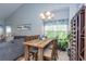 Bright dining area adjacent to living room features a wood table and natural light streaming in from the window at 100 Birch N Coppice Dr. # 12, Surfside Beach, SC 29575