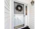 Charming front door with a wreath and lantern adds to the home's curb appeal at 100 Birch N Coppice Dr. # 12, Surfside Beach, SC 29575