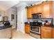 Efficient kitchen layout with stainless steel appliances, wooden cabinets, and tile flooring at 100 Birch N Coppice Dr. # 12, Surfside Beach, SC 29575