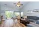 Bright living room boasts wood floors, vaulted ceilings, and access to a balcony at 100 Birch N Coppice Dr. # 12, Surfside Beach, SC 29575