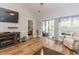 Spacious living room with fireplace, wood floors, and sliding doors to screened-in patio at 100 Birch N Coppice Dr. # 12, Surfside Beach, SC 29575