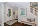 Inviting foyer features hardwood floors, bench seating, decorative rug and white trim at 1079 Milford Way, Myrtle Beach, SC 29588