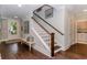Bright foyer features hardwood floors, bench seating, decorative rug, stairs and white trim at 1079 Milford Way, Myrtle Beach, SC 29588
