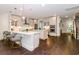 Spacious kitchen with white cabinets, quartz countertops, pendant lights and hardwood flooring at 1079 Milford Way, Myrtle Beach, SC 29588