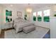 Inviting main bedroom with natural light, neutral colors, chandelier, and wood accent wall at 1079 Milford Way, Myrtle Beach, SC 29588