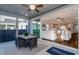Relaxing screened porch with ceiling fan, dining table and a view of the living room at 1079 Milford Way, Myrtle Beach, SC 29588