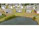 Aerial view of house and backyard with covered porch overlooking a pond and surrounding neighborhood at 1135 Sennema Circle, Myrtle Beach, SC 29588