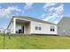 Exterior view of home with back porch, siding, and a lush green lawn at 1135 Sennema Circle, Myrtle Beach, SC 29588