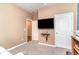 Bedroom featuring gray carpet, beige and blue walls, ceiling fan, and a wall-mounted television at 1135 Sennema Circle, Myrtle Beach, SC 29588