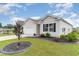 Charming single-story home with an attached one car garage, complemented by a landscaped yard and a serene neighborhood setting at 1135 Sennema Circle, Myrtle Beach, SC 29588