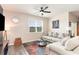 Cozy living room showcasing a comfortable sofa, bright window, and ceiling fan, perfect for relaxation at 1135 Sennema Circle, Myrtle Beach, SC 29588