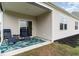 Covered patio with two chairs and a table, plus a view of the backyard and blue sky at 1135 Sennema Circle, Myrtle Beach, SC 29588