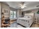 Cozy bedroom with a ceiling fan, closet, and small desk near a sunny window at 1208 S Ocean Blvd. # H, North Myrtle Beach, SC 29582
