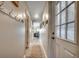 Inviting hallway with decorative wall art, coat rack, and a view into the cozy living area at 1208 S Ocean Blvd. # H, North Myrtle Beach, SC 29582