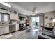 Living room/kitchen space with stainless steel appliances, ceiling fan, and a sliding glass door to a private balcony at 1208 S Ocean Blvd. # H, North Myrtle Beach, SC 29582