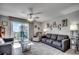 Living room with tile floors, beach decor, and a sliding glass door to a private balcony at 1208 S Ocean Blvd. # H, North Myrtle Beach, SC 29582