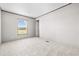 Neutral bedroom with soft carpet, white walls, natural light from the window, and a minimalist aesthetic at 121 Forman Way, Aynor, SC 29511