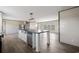 Bright open-concept kitchen features a central island with sink, stainless steel appliances, and modern lighting at 121 Forman Way, Aynor, SC 29511