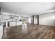 Modern kitchen with wood-look flooring, stainless steel appliances, a large kitchen island, and white cabinetry at 121 Forman Way, Aynor, SC 29511
