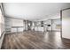 Open-concept living area with wood-look floors, white cabinetry, a kitchen island, and natural light at 121 Forman Way, Aynor, SC 29511
