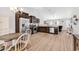 Open kitchen features stainless appliances, wooden cabinetry, and views to the living room at 122 Desurrency Ct., Georgetown, SC 29440