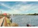 Beautiful waterfront view with boats, docks, and charming riverside buildings under a partly cloudy sky at 122 Desurrency Ct., Georgetown, SC 29440