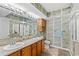 Bathroom featuring dual sinks, decorative wallpaper, and ample counter space at 1401 S Ocean Blvd. # 506, North Myrtle Beach, SC 29582