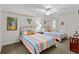 Bright bedroom featuring two beds with colorful striped bedding and a ceiling fan at 1401 S Ocean Blvd. # 506, North Myrtle Beach, SC 29582